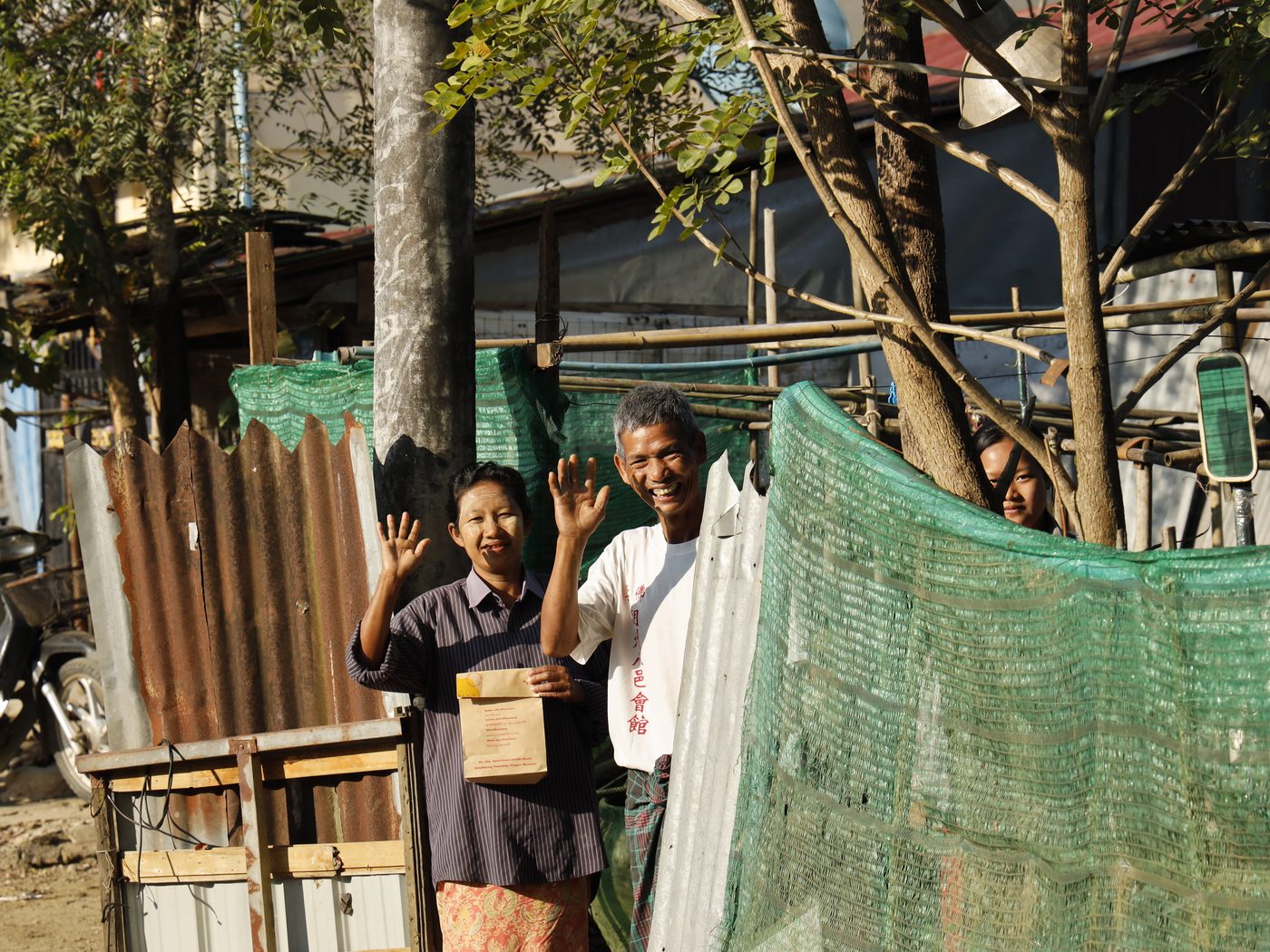 Pharmacy staff greeting patients outside a Common Health partner pharmacy
