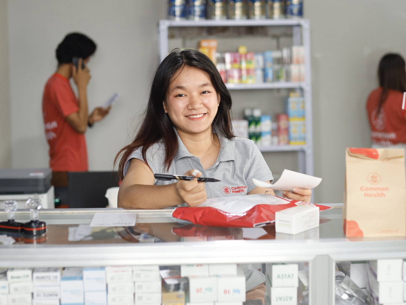 Common Health team member handing over a medicine delivery to a patient